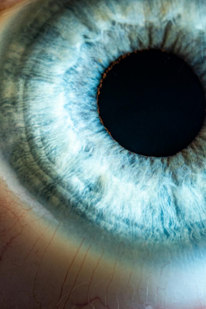 Detailed macro shot of a human blue eye revealing intricate patterns and textures.